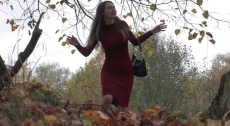 Distressed girl Sasha S hikes up her long dress to pee beside an old tree