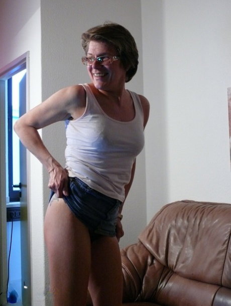 German housewife with glasses Kathy fingers and toys her hairy pussy