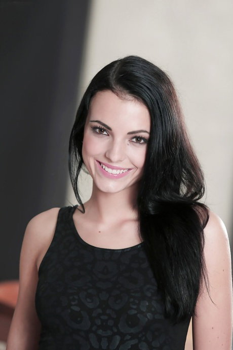Slender brunette with cute smile Sapphira is taking off her clothes