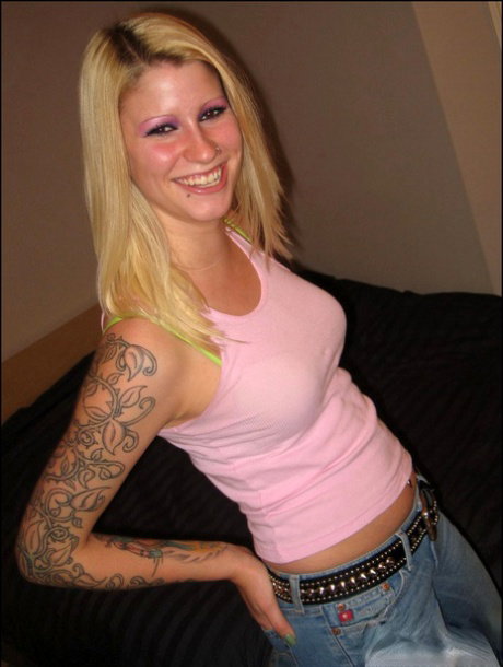 Tattooed blonde teen Ivy strips to her bra and thong ensemble