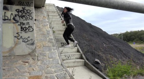 Dark haired girl Dee pulls down her leggings for a pee on concrete stairs