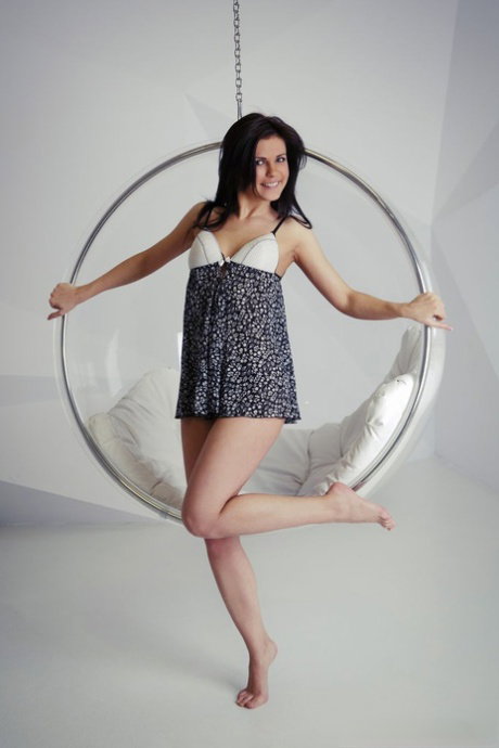 Brunette solo model Zelda B uncovers her small breasts and then her naked twat