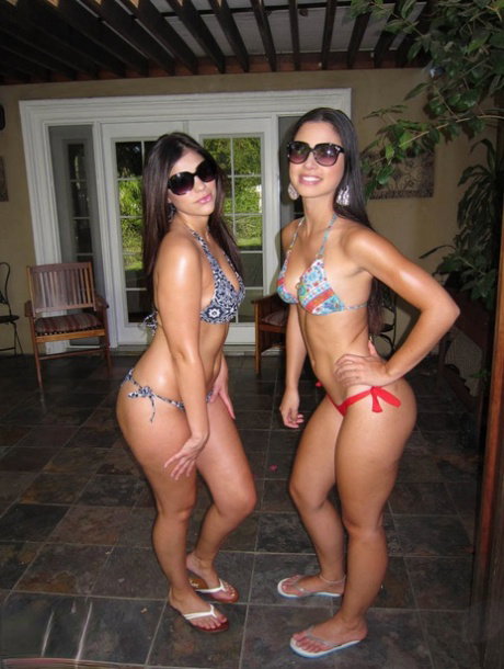Amateur brunette hotties with sexy asses posing in bikinis outdoor