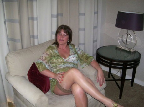 Mature lady Cassandra Uk slides her panties aside after showing her nipples