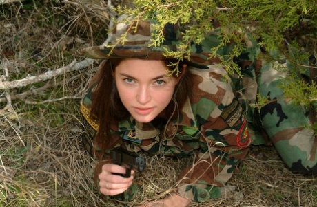 Sexy military woman Josie shows her lovely tits and her hairy pussy outdoors