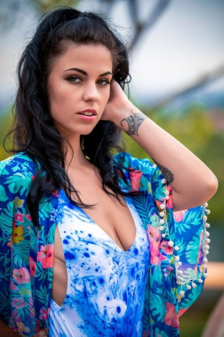 Brunette amateur Aemelia Fox uncovers small tits while getting nude on a patio