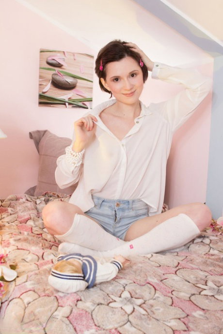 Brunette teen with short hair and tiny boobs poses nude in knee socks