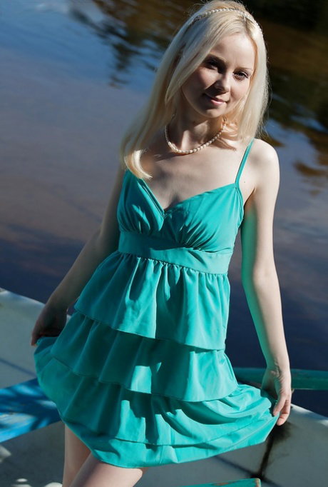 Blonde babe with small tits undressing and shoting her body outdoor