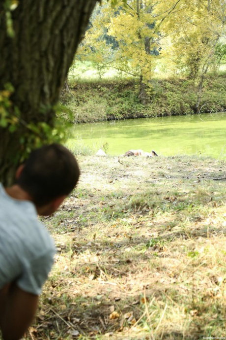 Czech teen Naomi Bennet sees a voyeur and decides to spread legs by water