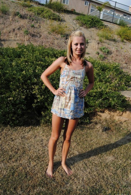 Blond amateur Tiny Tiff removes a summer dress and thong to stand nude outside