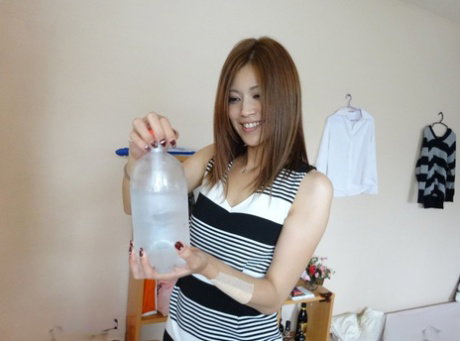 Brunette Asian housewife Rena Fuji shows her hairy twat and rides a dick