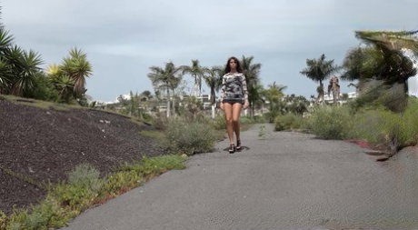 Hot girl Sexy Lexy squats for a piss on a paved road during the day