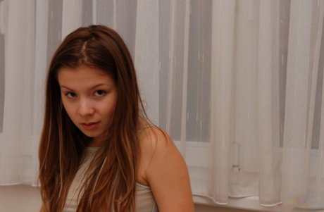 Cute teen wiggles her sexy ass while going topless in a thong