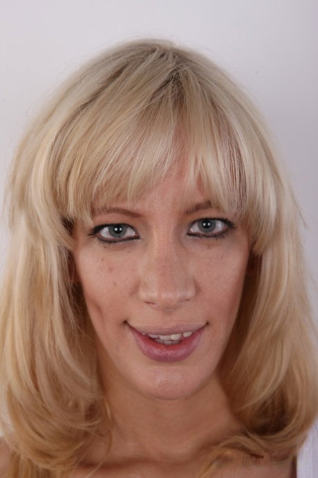 Blonde amateur sits on a stool after taking off all of her clothing