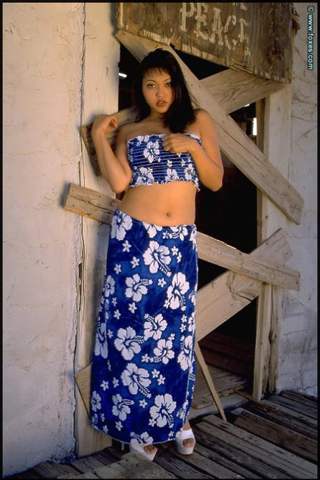 Middle-aged Asian woman Mika Tan spreads her pink pussy in a rural setting