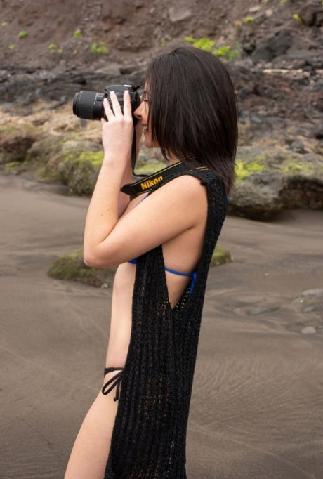Raven-haired teen Dionisia stripping on the beach and posing naked