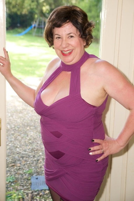 Mature plumper Dirty Doctor sports short hair while unveiling her natural tits