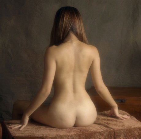 Asian solo girl poses naked in a bedroom while draping a towel over her shaved c