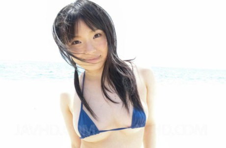 Japanese girl Hina Maeda loses her bikini top during a POV blowjob at a beach