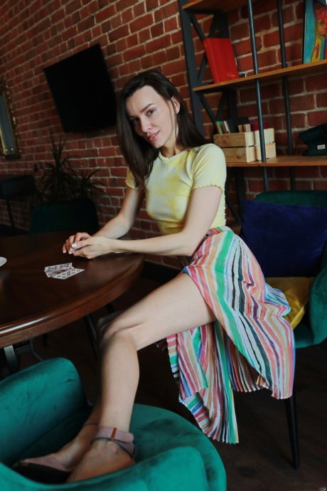 Skinny teen Adel Morel plays cards before stripping to her shoes