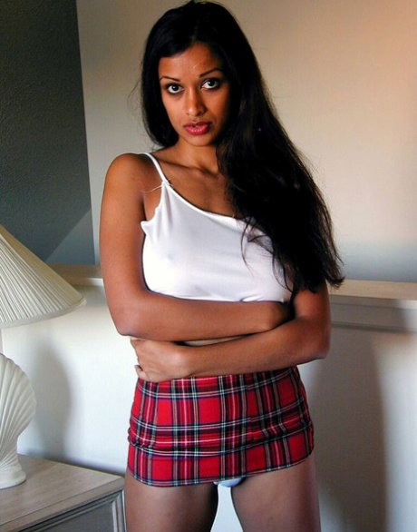 Pretty Indian girl exposes her round boobs and cotton panties on a bed