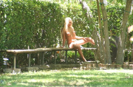 Blonde lesbians go bare naked for a dip in an outdoor swimming pool