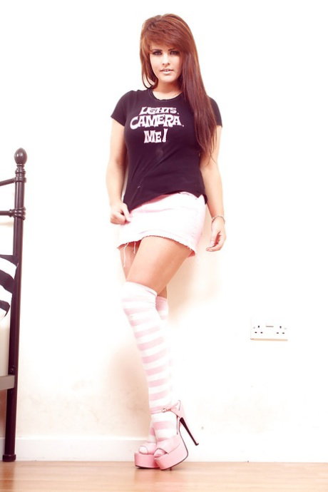 Fuckable teenage brunette in stockings uncovering her big jugs