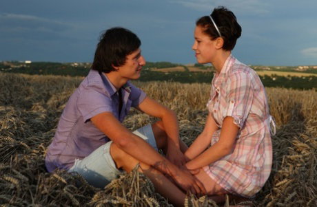 Young couple have sexual intercourse in the shade out in a farmer's field