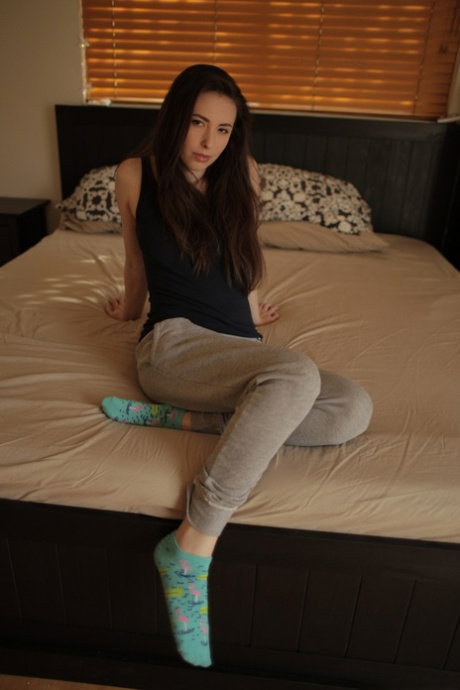 Brunette American pornstar Casey Calvert fingering her ass in the bed