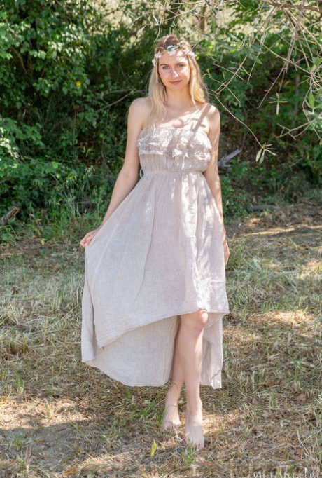 Sweet blonde teen Emily Swan gets naked in a treed area that provides shade