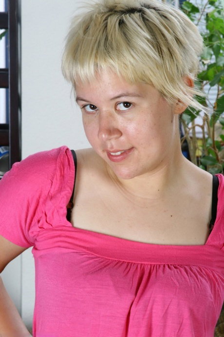 Amateur girl with short blonde hair spreads her full bush while naked
