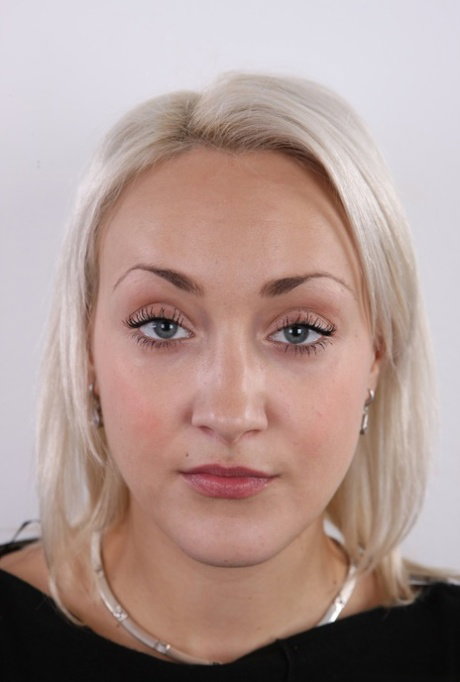 Platinum blonde amateur Lucie stands naked after losing her clothing