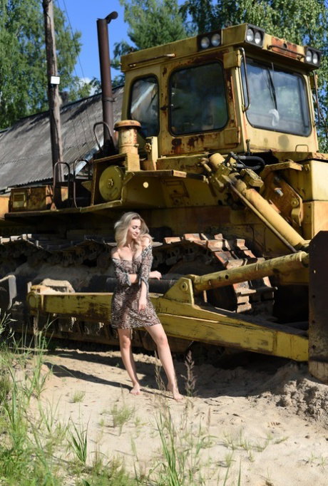 Young blonde Ava List gets totally naked in front of a bulldozer
