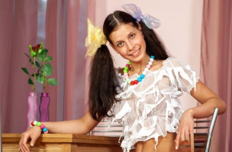 Young girl Anoushka E wears ribbon in her pigtails while sporting booty shorts
