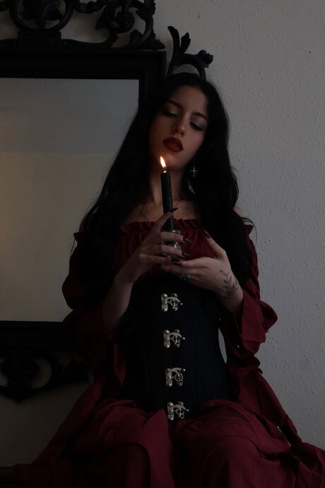 Goth girl Kore Fox blows out a candle before lighting one on her tongue
