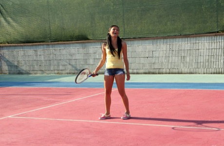 Lesbian tennis players use sex toys while having sex on a bench