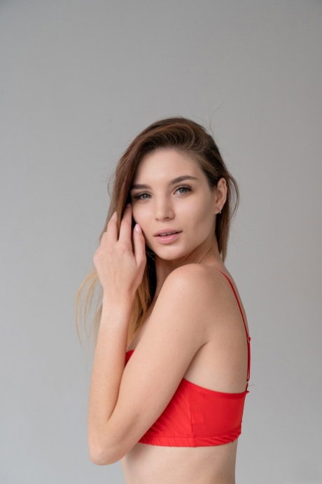 Teen beauty Emilia Hops losing her red lingerie and posing naked