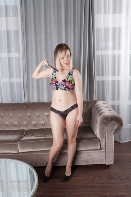 Attractive blonde Sasha K shows unshaved legs & brushes her hairy vagina