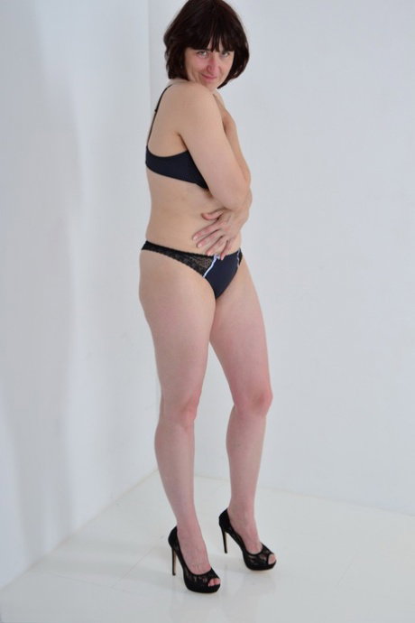 Mature woman with bra and boy shorts to model totally naked in black pumps