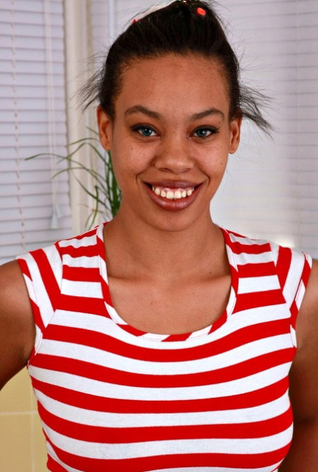 Hot black teen strips down to her bare feet with her red nails spread wide