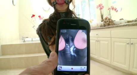 Lily Carter is ball gagged before hardcore anal sex gets underway
