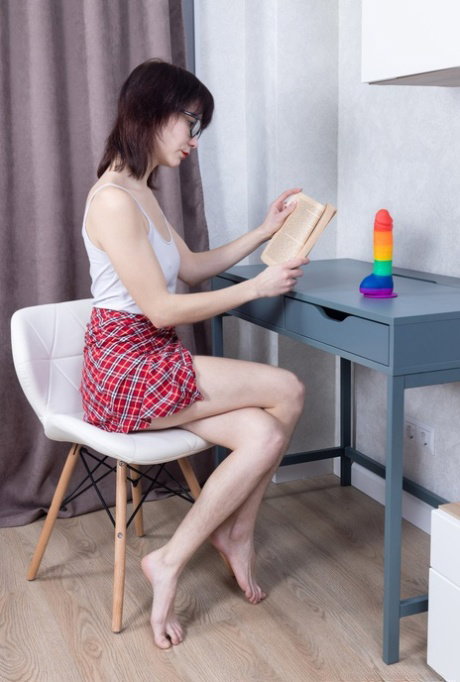 Nerd Polly White deepthroats a colorful dildo & fucks her hairy pussy with it