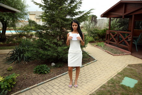 Dark-haired teen gets totally naked while in a backyard setting