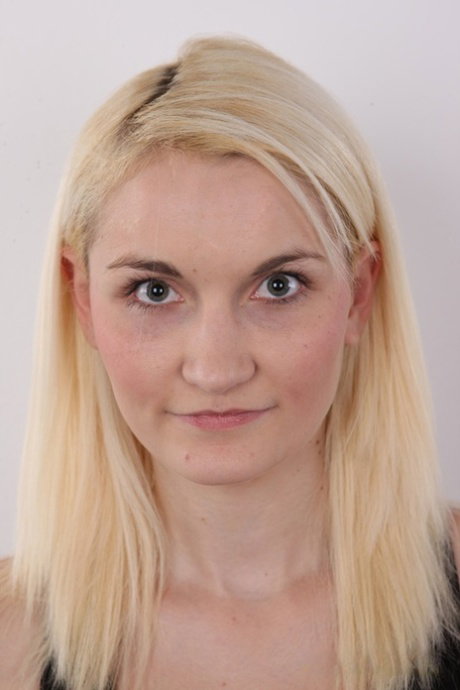 Blonde amateur strips off her clothes to pose totally naked on a stool