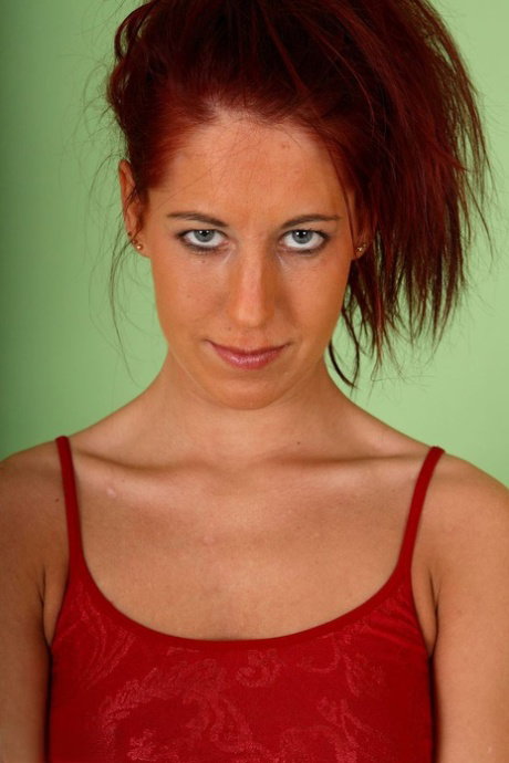 Skinny redhead Susy Rocks takes a big dildo to her shaved vagina