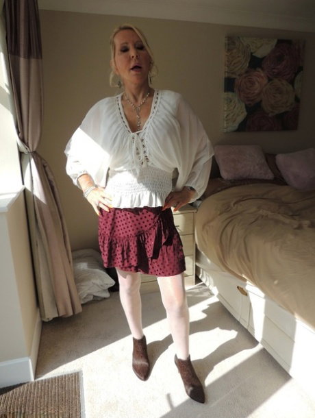 Mature blonde Emerald frees her big tits after playing with her vagina