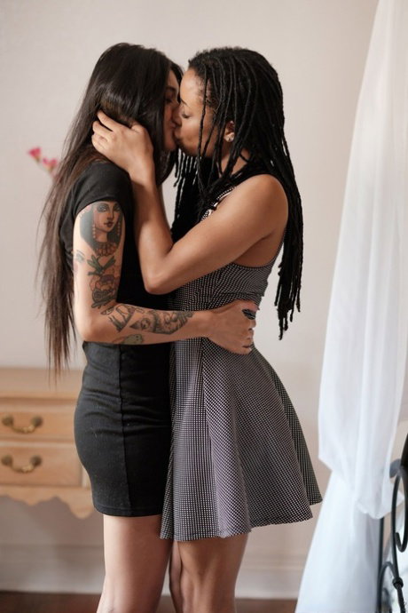 Ebony Kira Noir and her lesbian babe Brenna Sparks having fun with a strapon