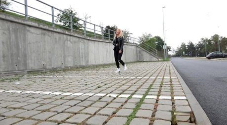 Blonde girl Jena Lovely pulls down black leggings for a pee near an overpass