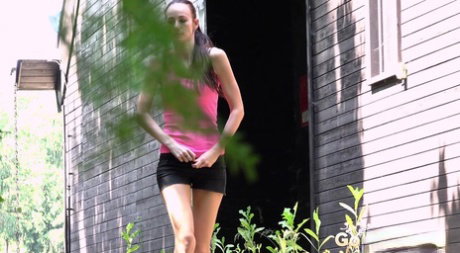 White girl Eveline Neill looks around while taking a pee in a lane