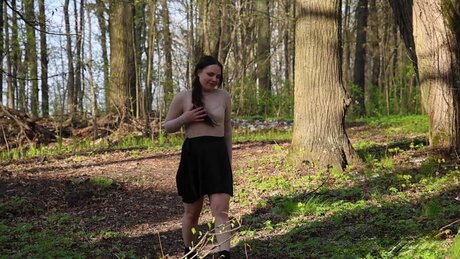 Nice girl Violet Rilz takes a piss on a rock by a pond in a black skirt